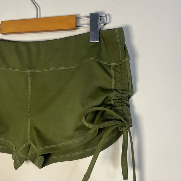 Green Athletic Shorts with Adjustable Side Ties and Curved Hem - Picture 2 of 6